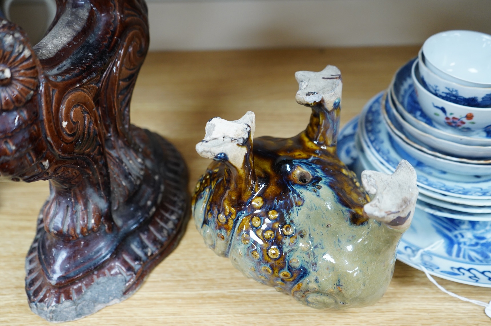 A late 19th century glazed pottery grotesque three legged toad spoon warmer in the manner of Dunmore or Burmantofts, and a Doulton owl andiron, largest 24cm high